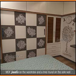 MDF Jaalis on the wardrobe and a tree mural on the side wall